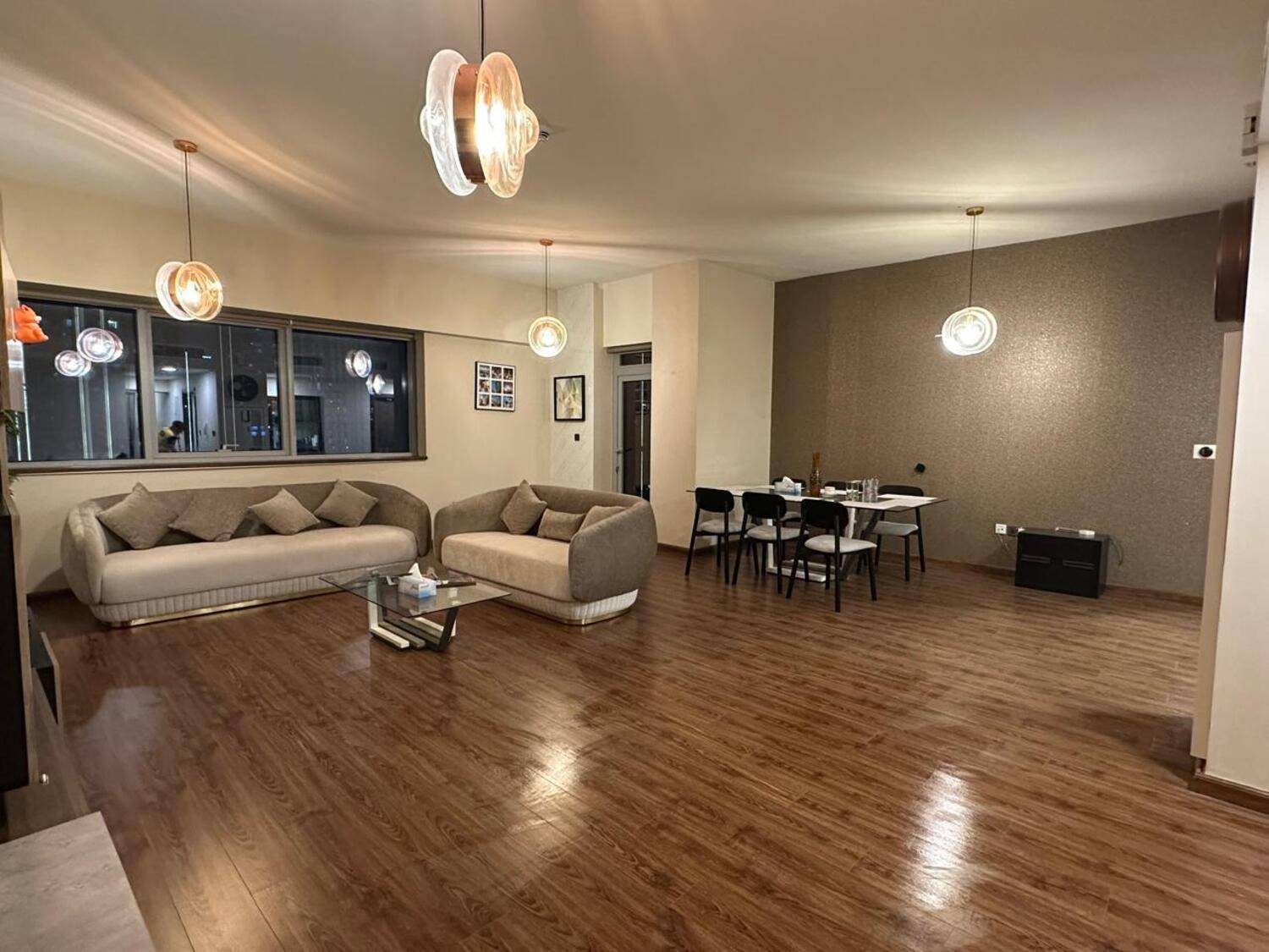 Assorted succulent plants in a glass jar.